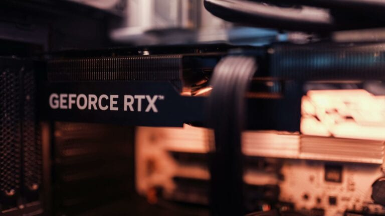 Detailed view of a GeForce RTX graphics card installed in a computer setup, highlighting modern technology.